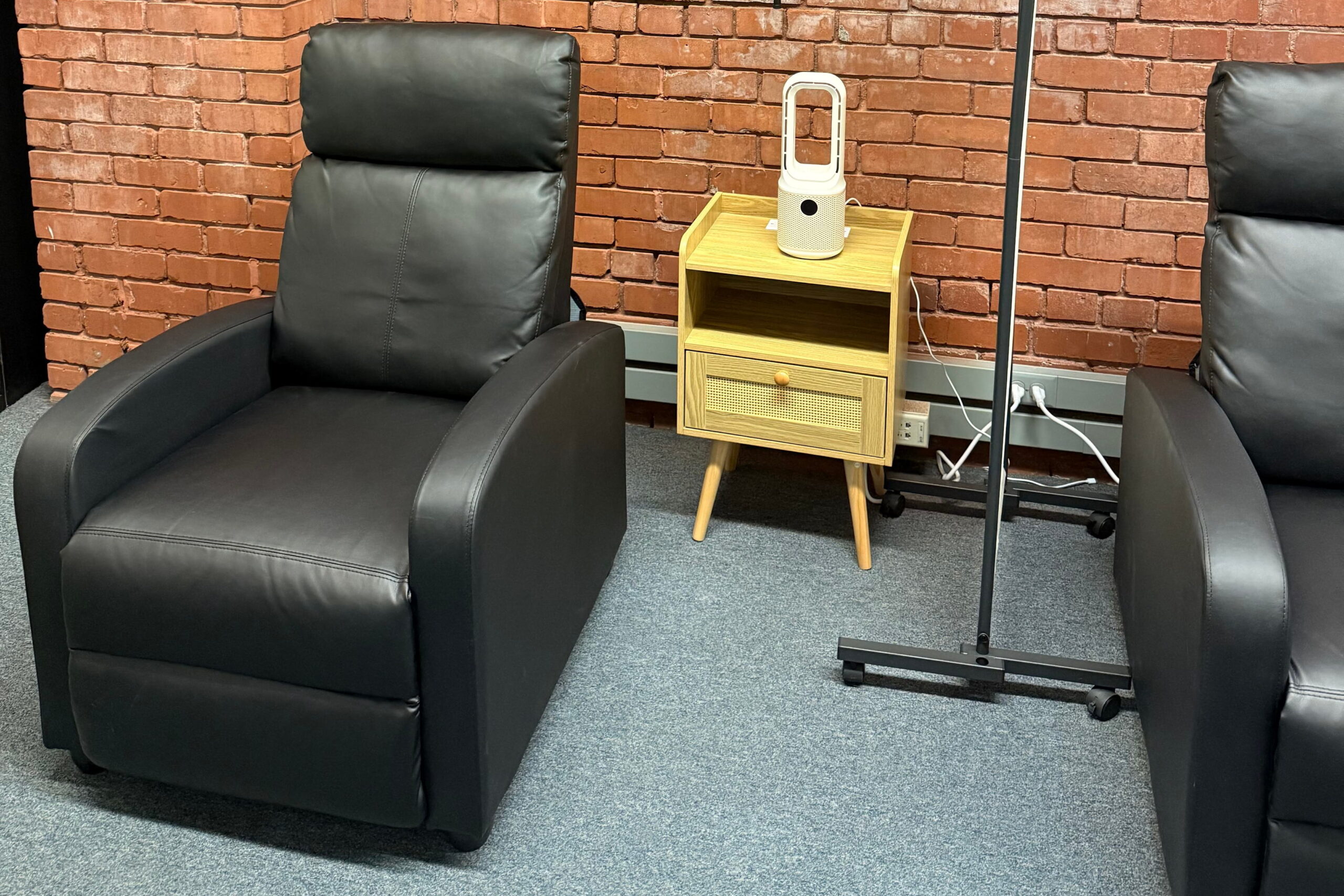 black leather recliner and end table at ketamine clinic