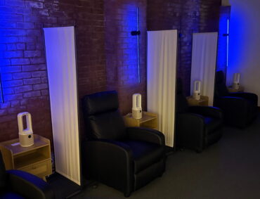 row of recliners with blue lights at ketamine treatment center